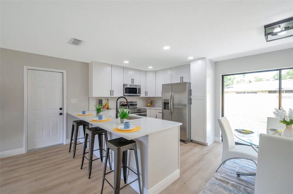 Dining room, Interior, Kitchen, Recessed Lighting, Stainless Steel Appliances, Wood Texture Flooring