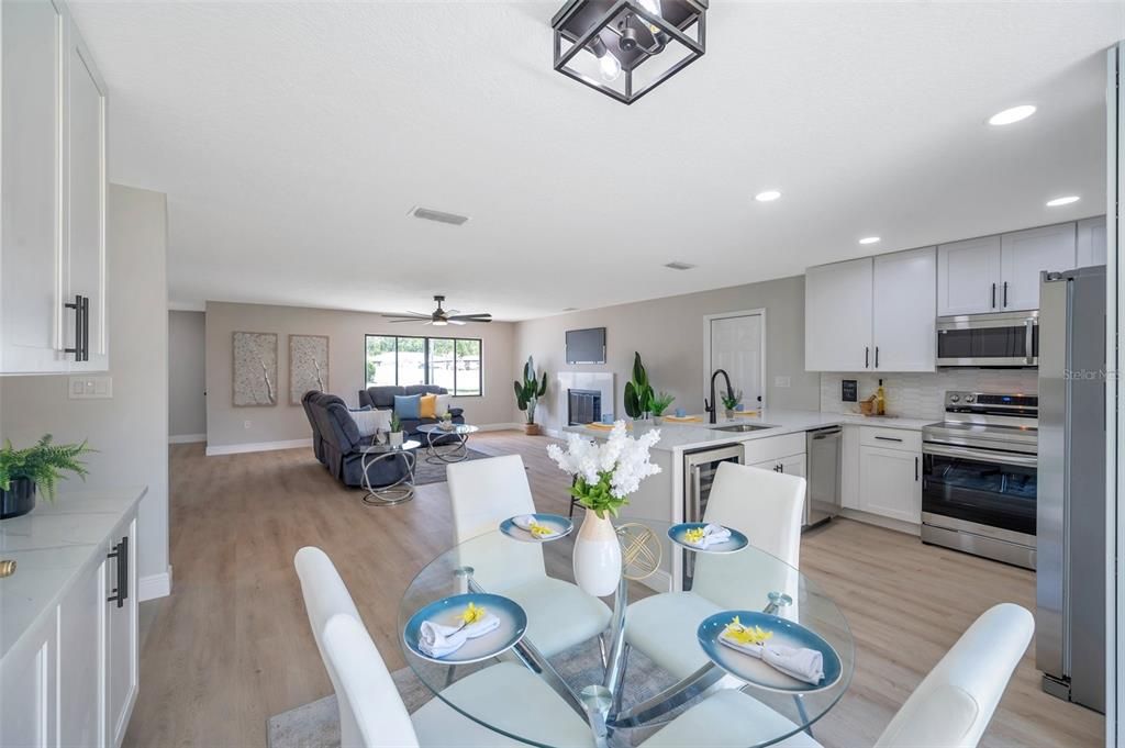 Dining room, Fireplace, Interior, Kitchen, Living room, Recessed Lighting, Stainless Steel Appliances, Wood Texture Flooring