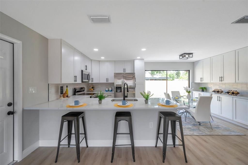 Dining room, Interior, Kitchen, Recessed Lighting, Stainless Steel Appliances, Wood Texture Flooring