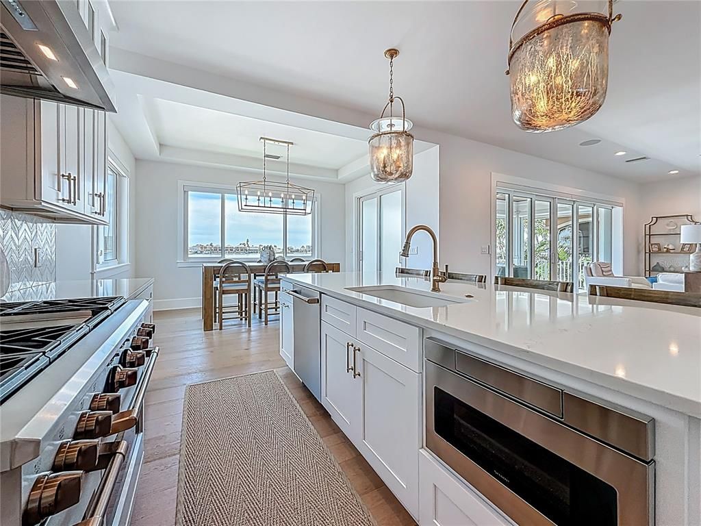 Chandelier, Dining room, Interior, Kitchen, Pendant Lights, Recessed Lighting, Stainless Steel Appliances, Wood Texture Flooring