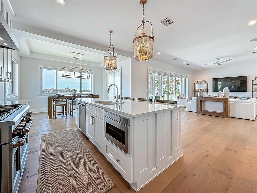 Dining room, Interior, Kitchen, Living room, Pendant Lights, Recessed Lighting, Stainless Steel Appliances, Water, Wood Texture Flooring