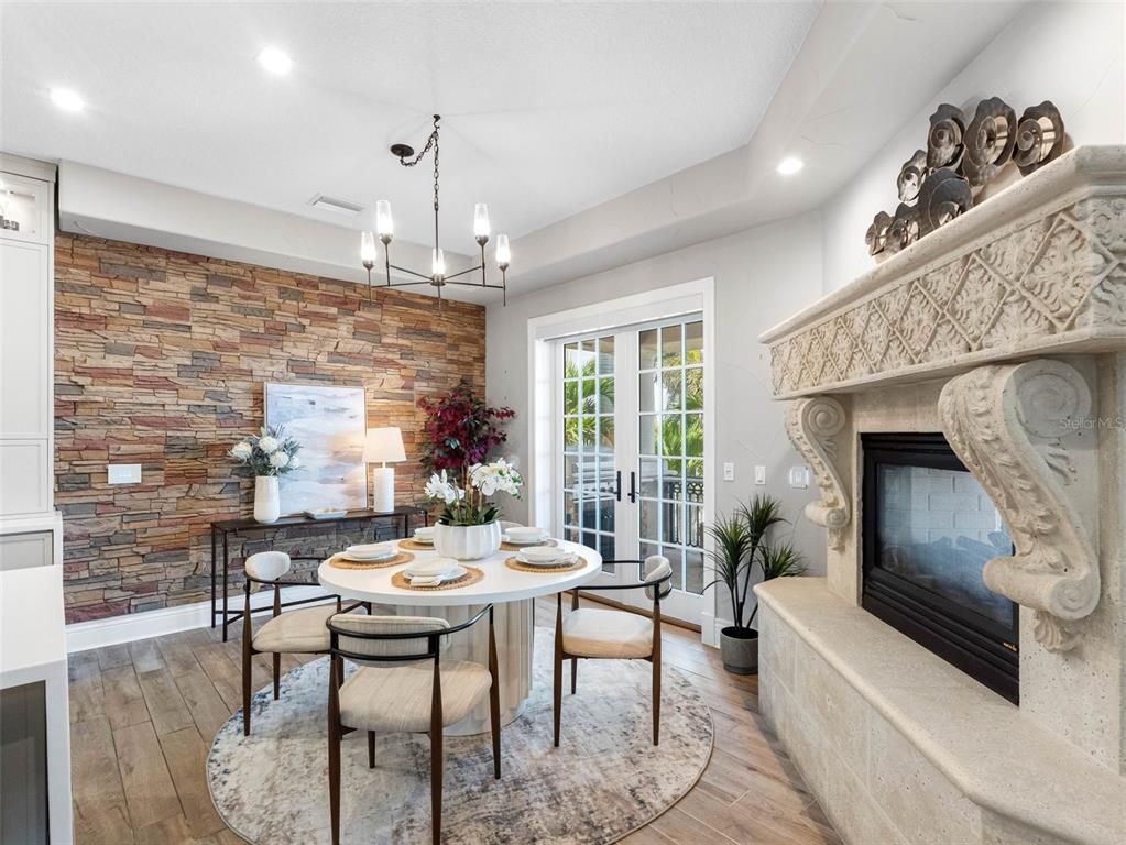 Chandelier, Dining room, Fireplace, Interior, Recessed Lighting, Stone Walls, Wood Texture Flooring