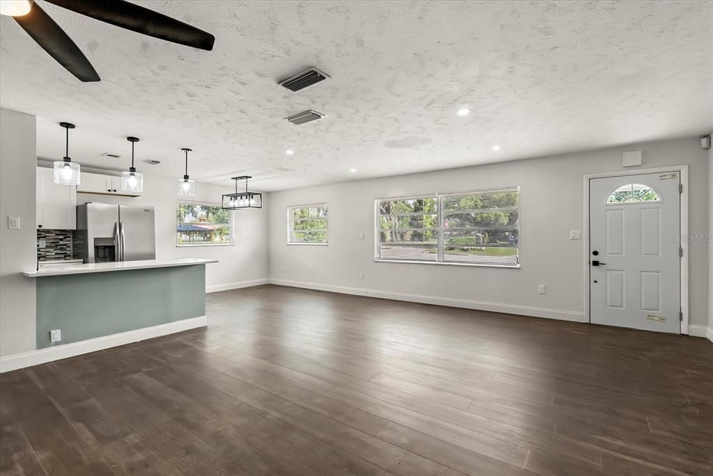 Empty room, Interior, Kitchen, Pendant Lights, Recessed Lighting, Stainless Steel Appliances, Wood Texture Flooring