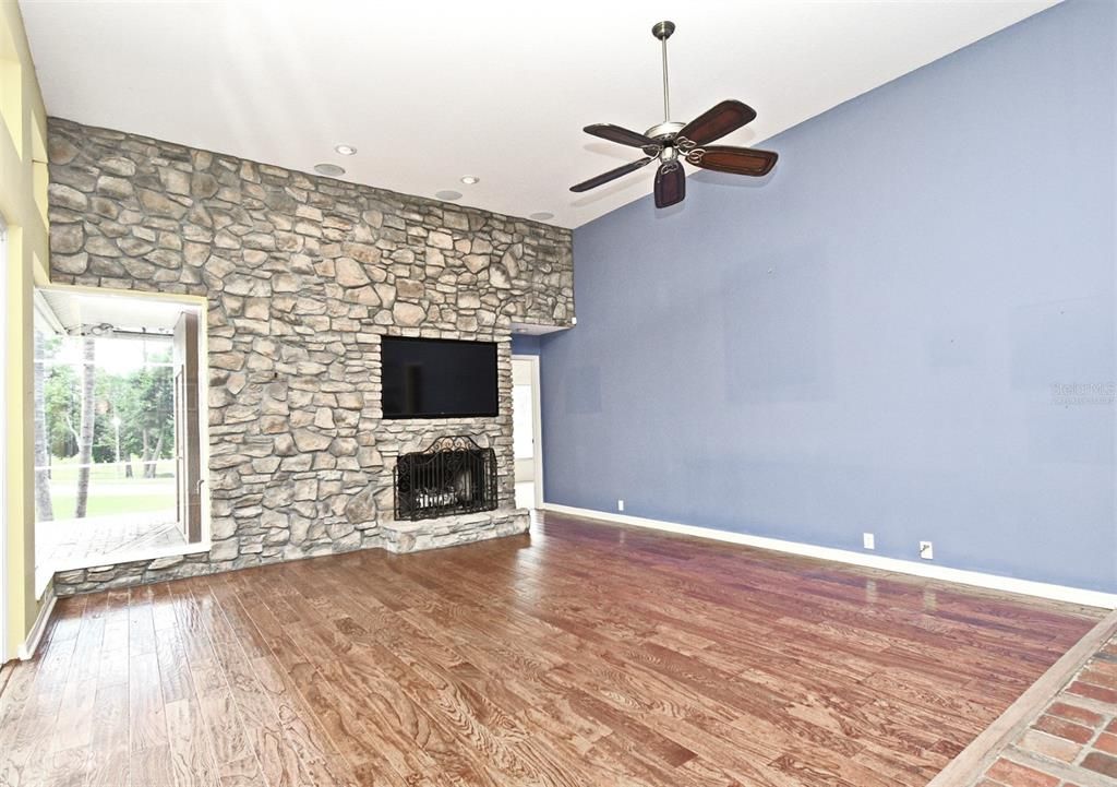Empty room, Fireplace, Interior, Recessed Lighting, Stone Walls, Wood Texture Flooring