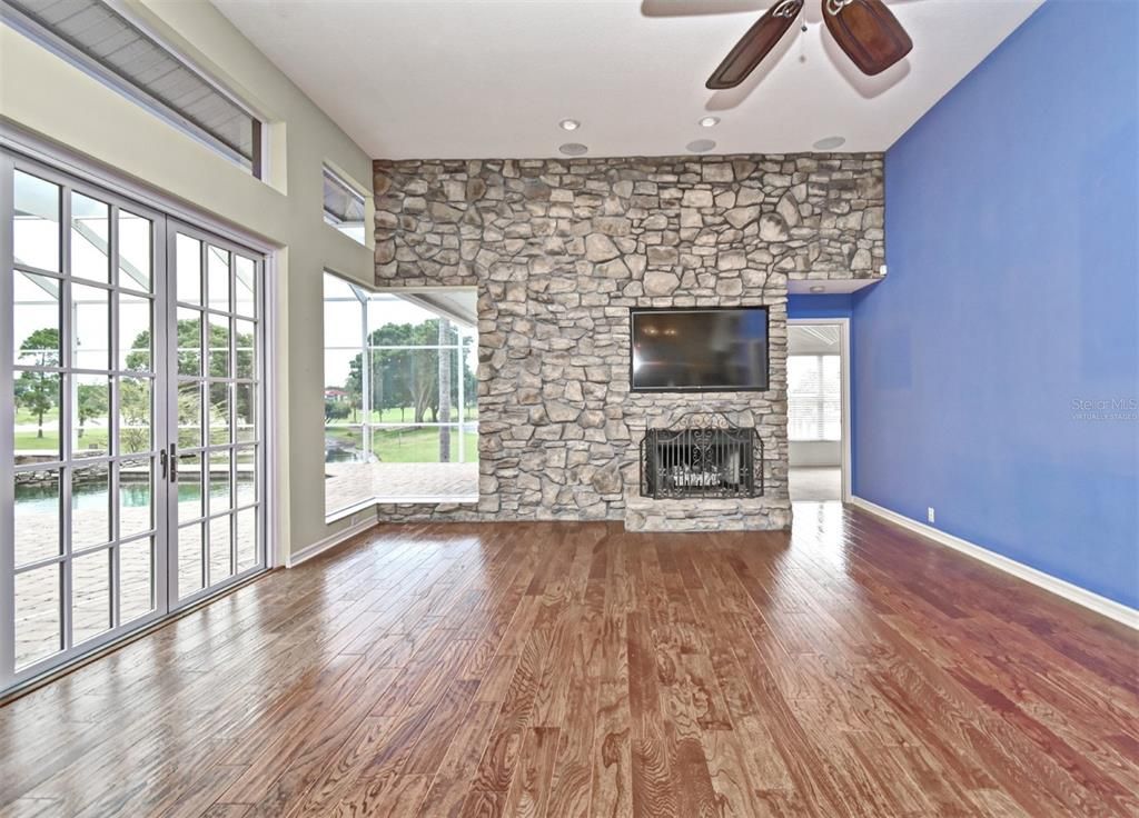 Empty room, Fireplace, Interior, Recessed Lighting, Stone Walls, Wood Texture Flooring