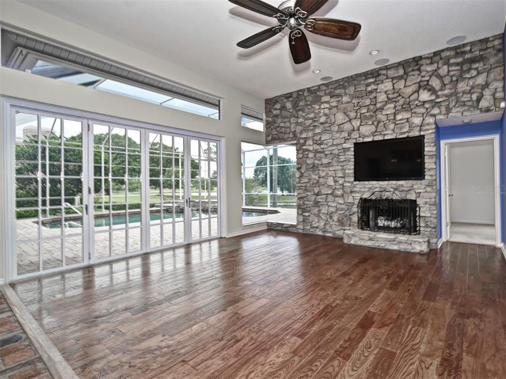 Empty room, Fireplace, Interior, Recessed Lighting, Stone Walls, Wood Texture Flooring