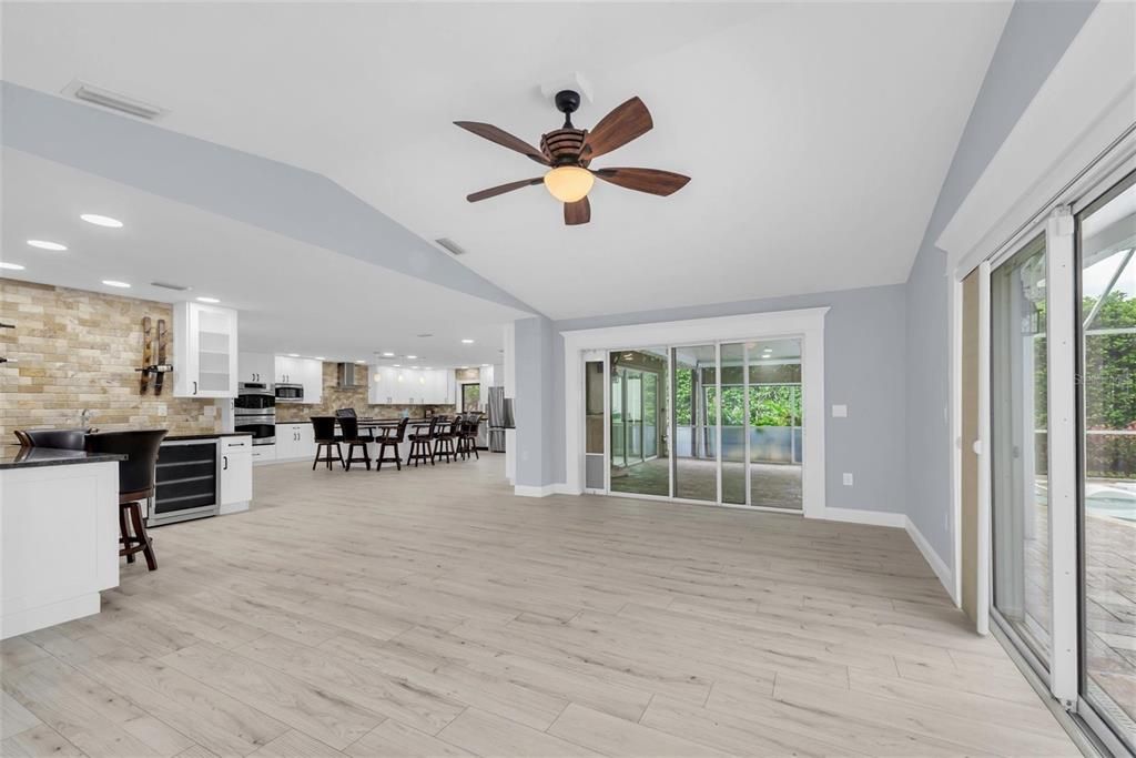 Dining room, Empty room, Interior, Kitchen, Pendant Lights, Recessed Lighting, Stainless Steel Appliances, Stone Walls, Wood Texture Flooring