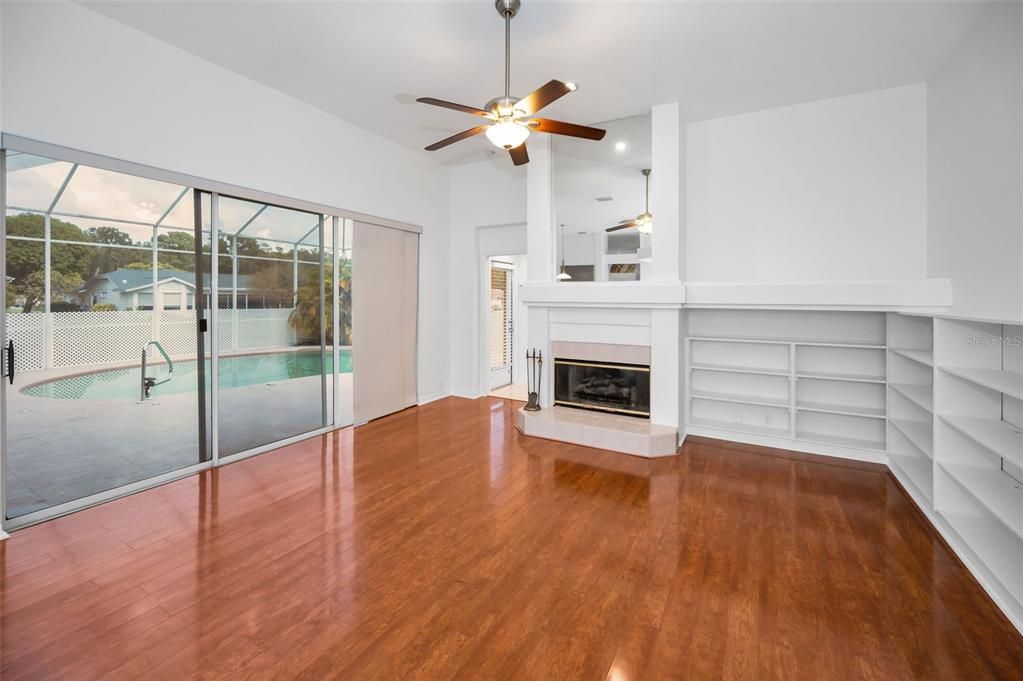 Empty room, Fireplace, Glass Ceilings, Interior, Pool, Recessed Lighting, Sun Room, Wood Texture Flooring