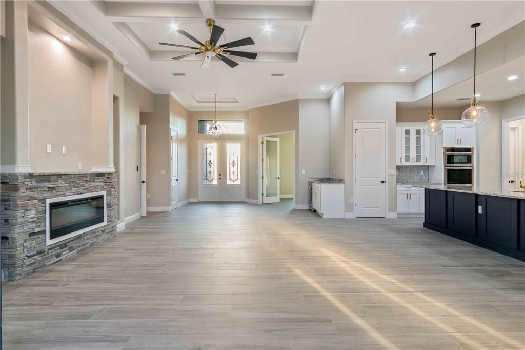 Fireplace, Interior, Kitchen, Pendant Lights, Recessed Lighting, Stainless Steel Appliances, Stone Walls, Wood Texture Flooring