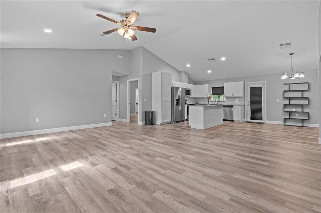 Empty room, Interior, Kitchen, Pendant Lights, Recessed Lighting, Stainless Steel Appliances, Wood Texture Flooring