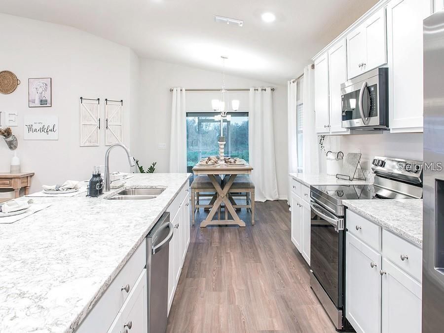 Dining room, Interior, Kitchen, Pendant Lights, Recessed Lighting, Stainless Steel Appliances, Wood Texture Flooring