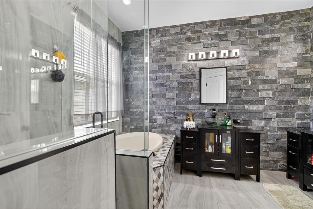 Bathroom, Dual Sink Vanities, Glass Shower, Interior, Recessed Lighting, Stone Walls, Wood Texture Flooring