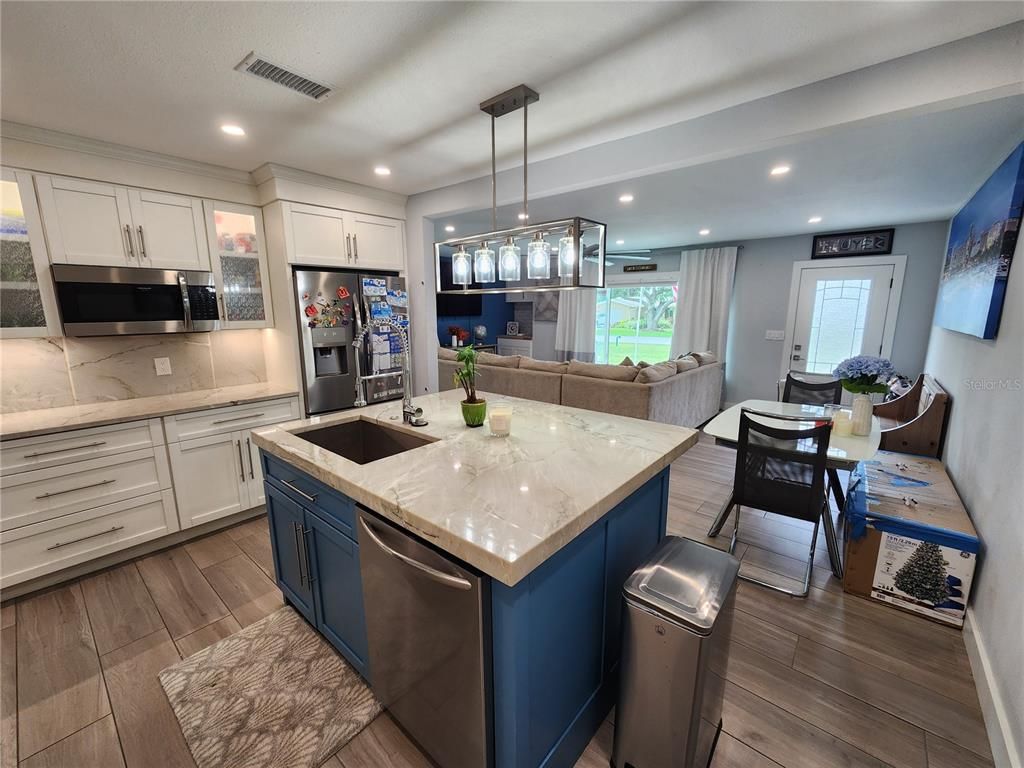 Dining room, Interior, Kitchen, Pendant Lights, Recessed Lighting, Stainless Steel Appliances, Wood Texture Flooring