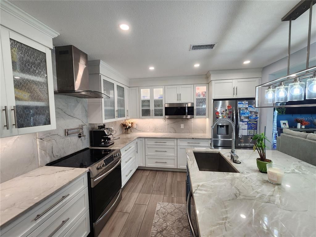 Interior, Kitchen, Marble Walls, Recessed Lighting, Stainless Steel Appliances, Wood Texture Flooring