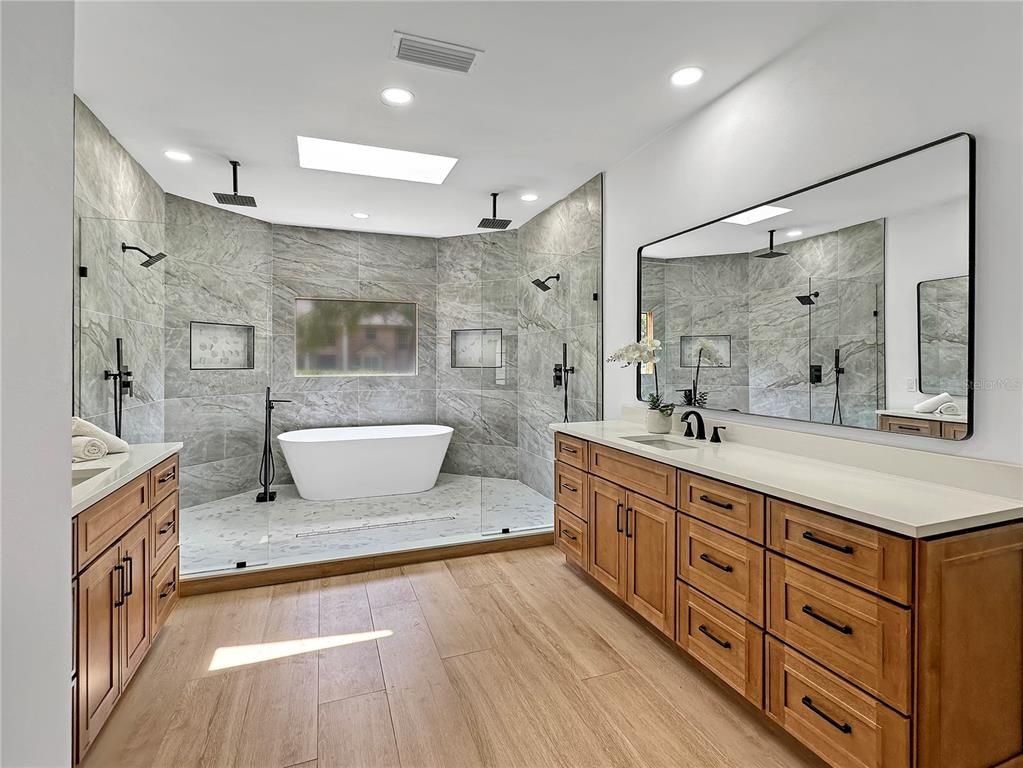 Bathroom, Dual Sink Vanities, Free Standing Baths, Glass Shower, Interior, Marble Walls, Recessed Lighting, Wood Texture Flooring