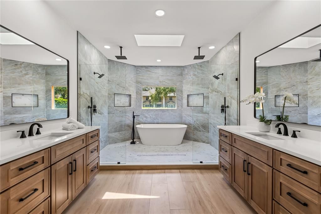 Bathroom, Dual Sink Vanities, Free Standing Baths, Glass Shower, Interior, Marble Walls, Recessed Lighting, Wood Texture Flooring