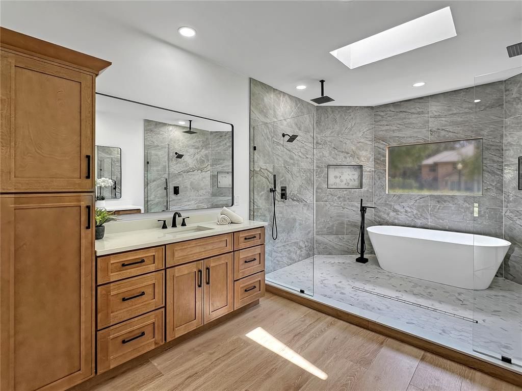 Bathroom, Dual Sink Vanities, Free Standing Baths, Glass Shower, Interior, Marble Walls, Recessed Lighting, Wood Texture Flooring