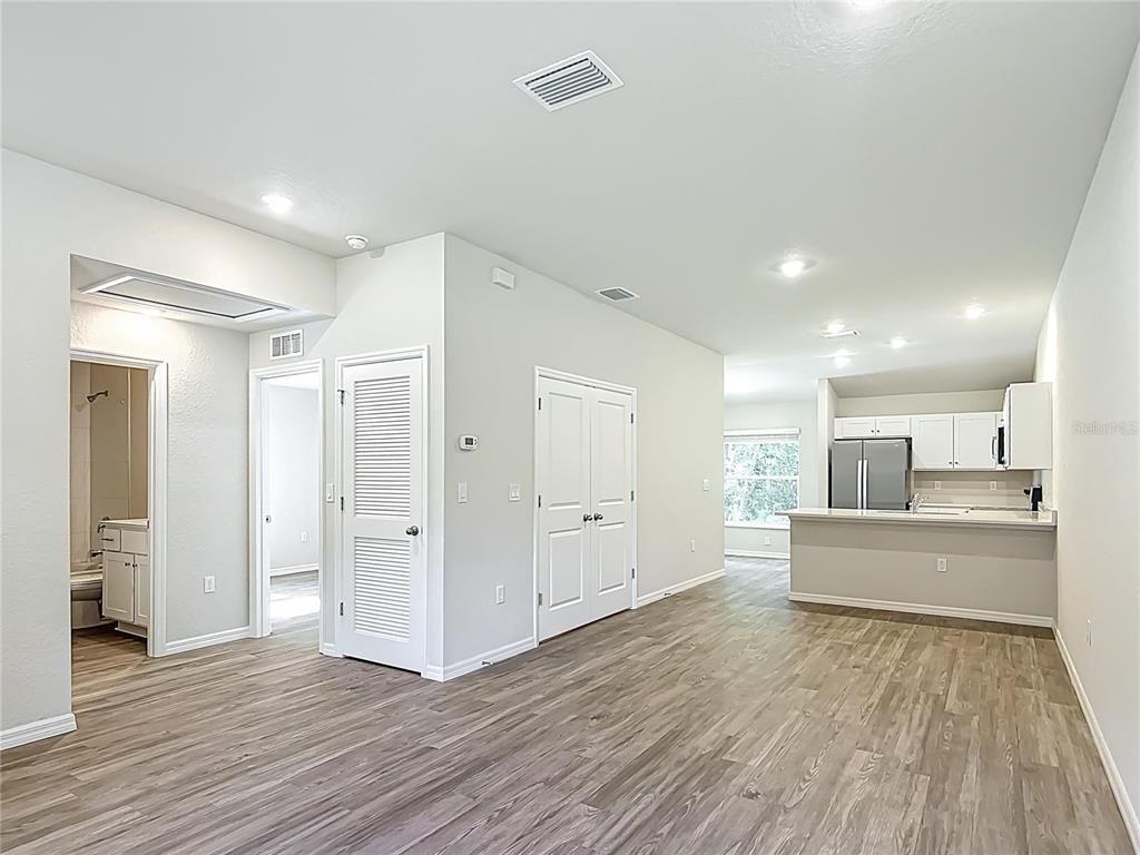 Empty room, Interior, Kitchen, Recessed Lighting, Stainless Steel Appliances, Wood Texture Flooring