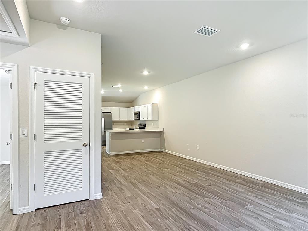 Empty room, Interior, Kitchen, Recessed Lighting, Stainless Steel Appliances, Wood Texture Flooring