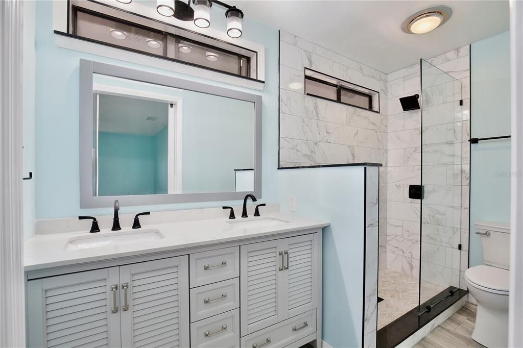 Bathroom, Dual Sink Vanities, Glass Shower, Interior, Marble Walls, Wood Texture Flooring