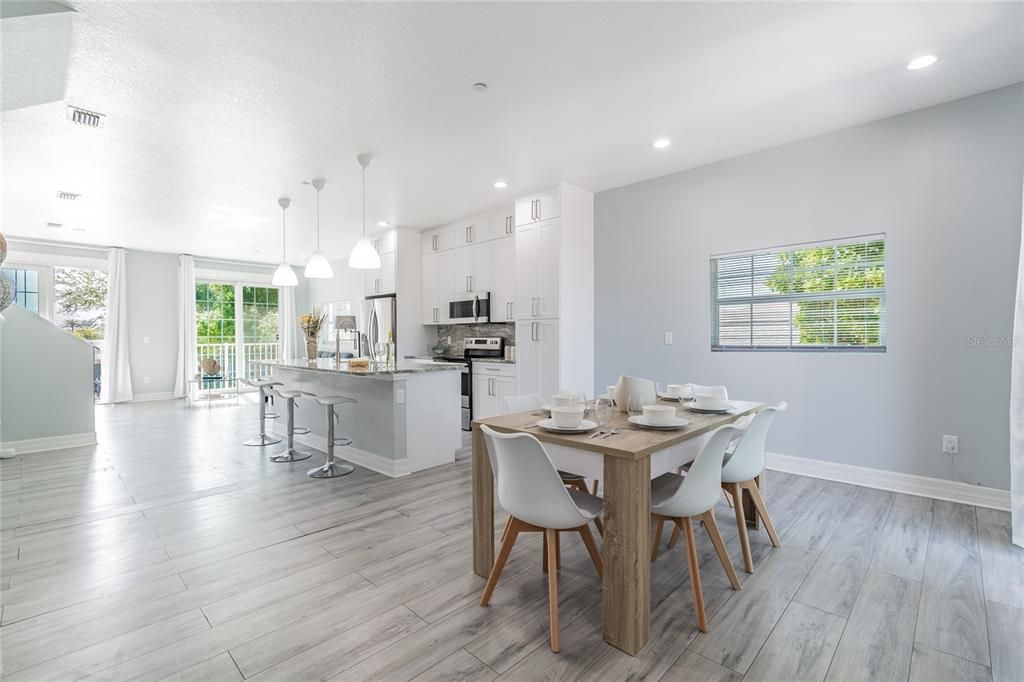 Dining room, Interior, Kitchen, Pendant Lights, Recessed Lighting, Stainless Steel Appliances, Wood Texture Flooring