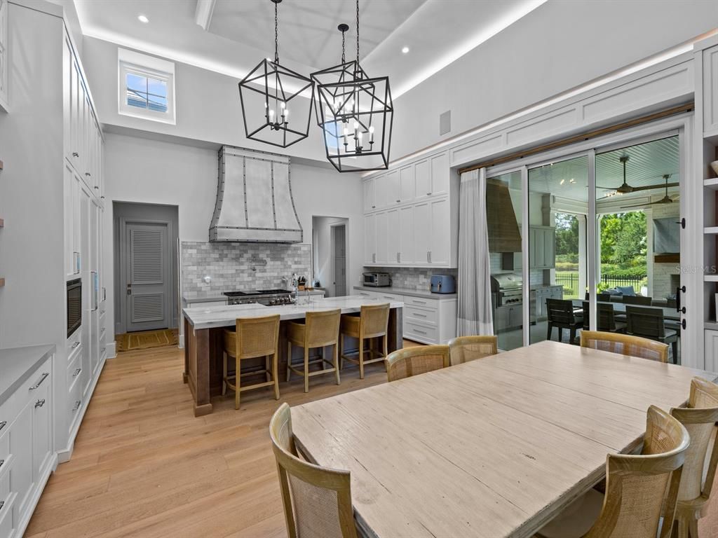 Chandelier, Dining room, Interior, Kitchen, Pendant Lights, Recessed Lighting, Stainless Steel Appliances, Wood Texture Flooring