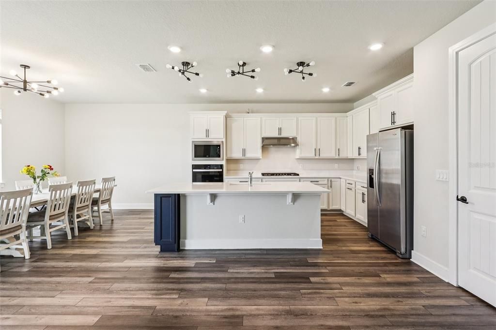 Dining room, Interior, Kitchen, Pendant Lights, Recessed Lighting, Stainless Steel Appliances, Wood Texture Flooring