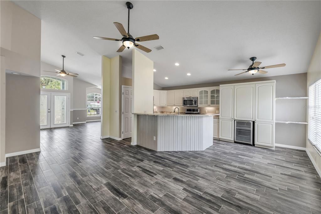 Empty room, Interior, Kitchen, Recessed Lighting, Stainless Steel Appliances, Wood Texture Flooring