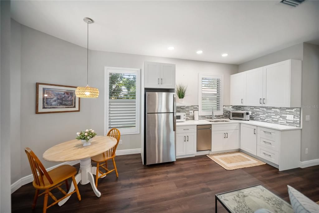 Dining room, Interior, Kitchen, Pendant Lights, Recessed Lighting, Stainless Steel Appliances, Wood Texture Flooring