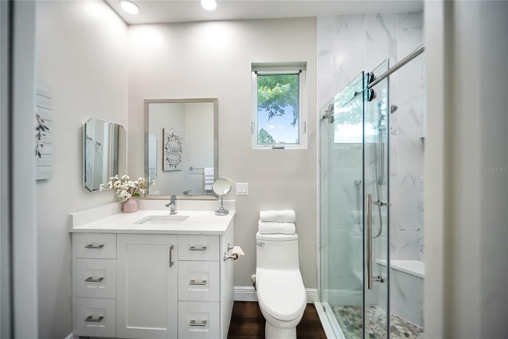 Bathroom, Glass Shower, Interior, Marble Walls, Recessed Lighting, Wood Texture Flooring