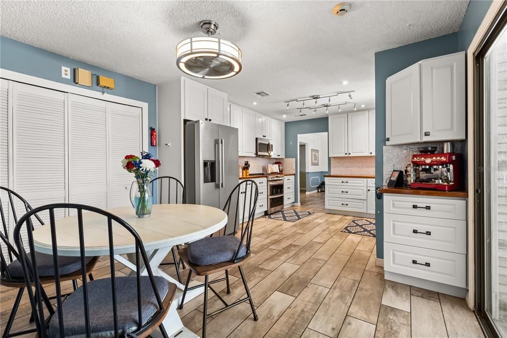 Dining room, Interior, Kitchen, Recessed Lighting, Stainless Steel Appliances, Wood Texture Flooring