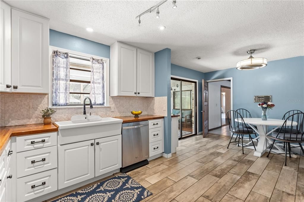 Dining room, Interior, Kitchen, Pendant Lights, Recessed Lighting, Stainless Steel Appliances, Wood Texture Flooring