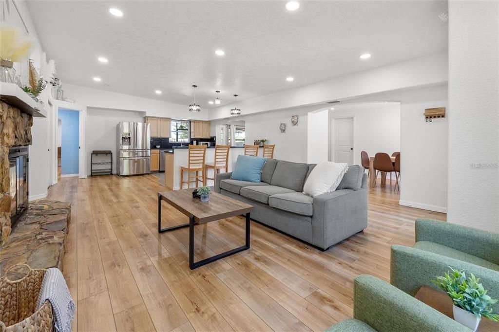 Dining room, Fireplace, Interior, Kitchen, Living room, Pendant Lights, Recessed Lighting, Stainless Steel Appliances, Wood Texture Flooring
