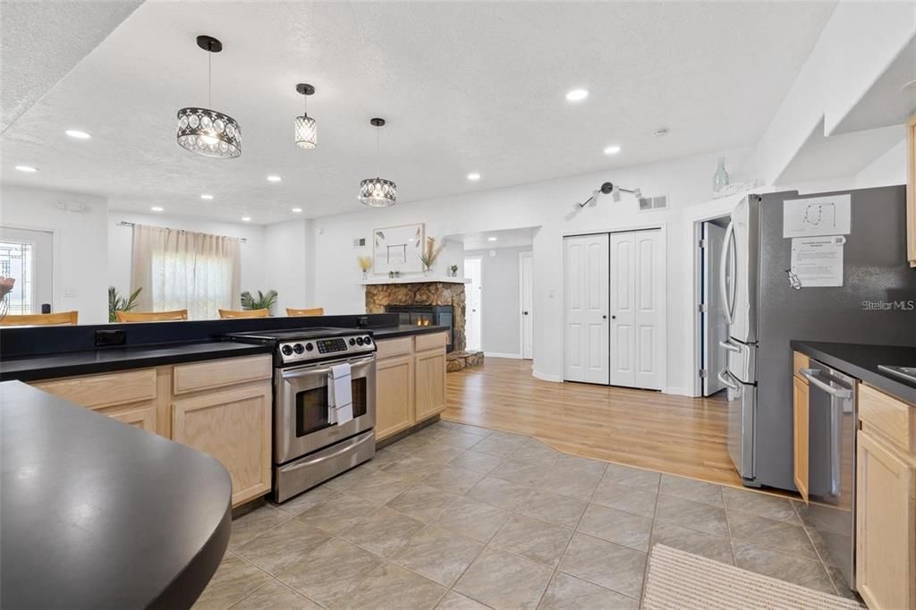 Fireplace, Interior, Kitchen, Pendant Lights, Recessed Lighting, Stainless Steel Appliances, Wood Texture Flooring