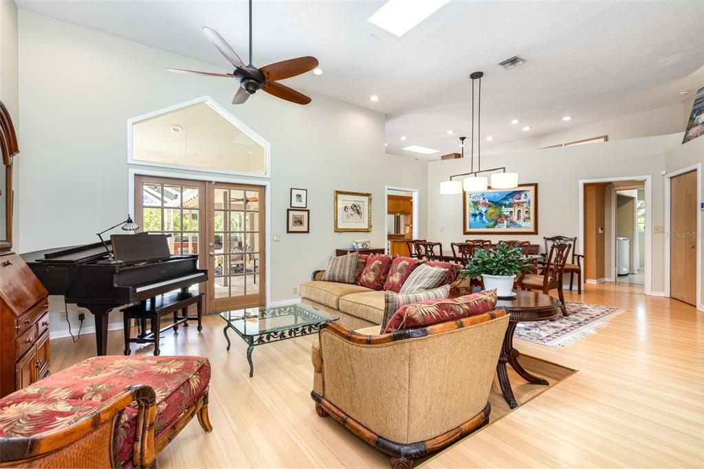 Dining room, Interior, Living room, Pendant Lights, Piano, Recessed Lighting, Wood Texture Flooring