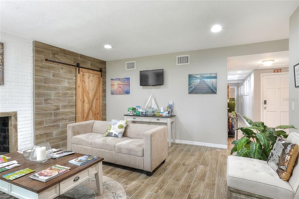 Fireplace, Interior, Living room, Recessed Lighting, Stone Walls, Wood Texture Flooring