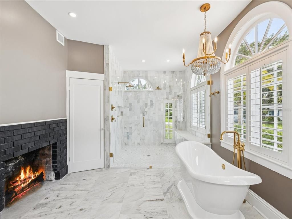 Bathroom, Chandelier, Fireplace, Free Standing Baths, Glass Shower, Interior, Marble, Marble Walls, Pendant Lights, Recessed Lighting