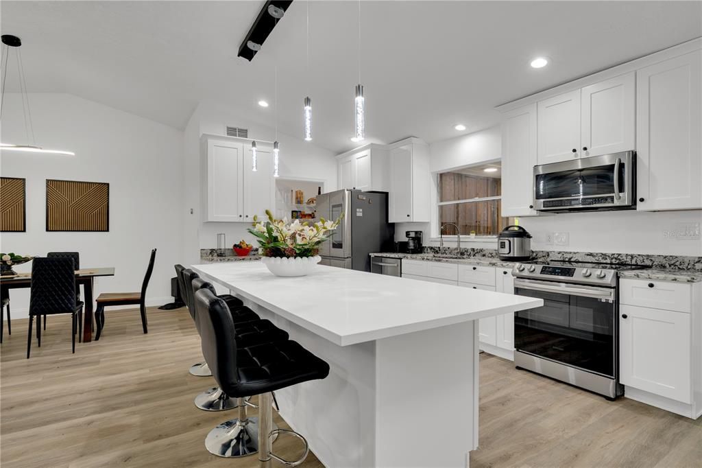 Dining room, Interior, Kitchen, Pendant Lights, Recessed Lighting, Stainless Steel Appliances, Wood Texture Flooring