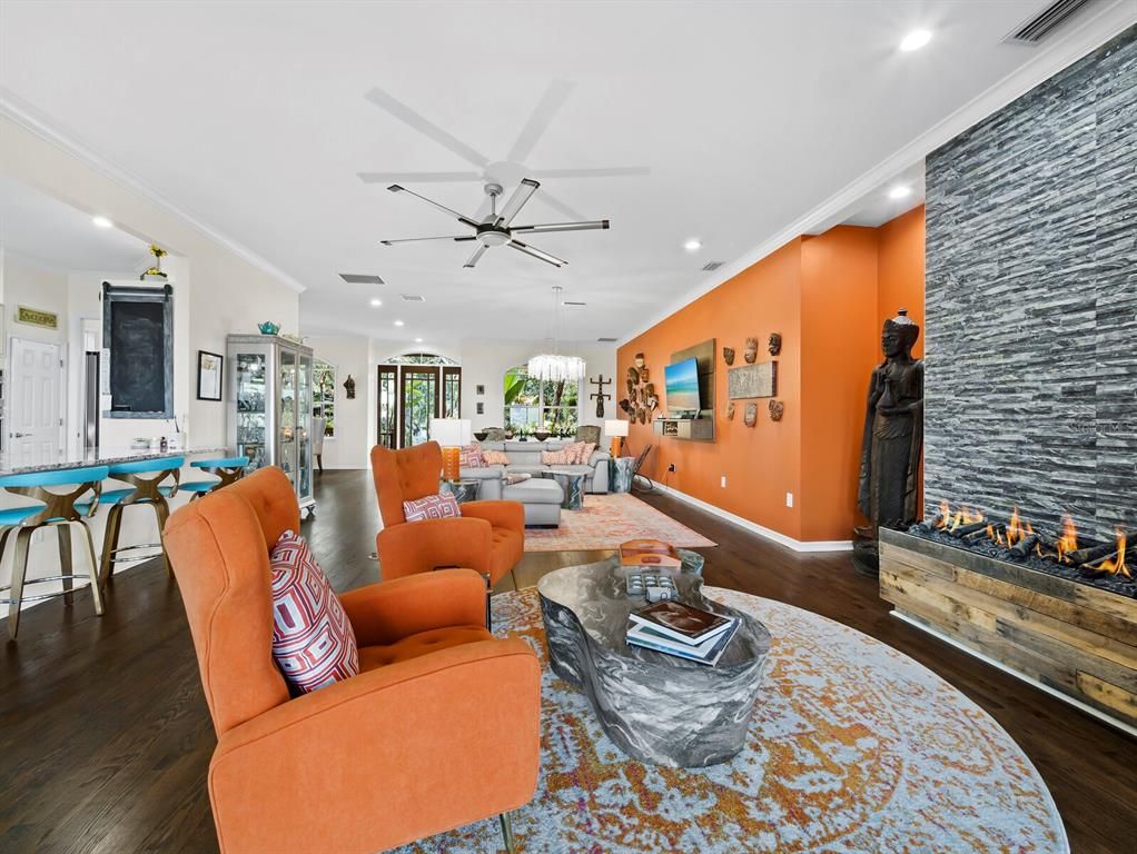 Chandelier, Dining room, Fireplace, Interior, Living room, Pendant Lights, Recessed Lighting, Wood Texture Flooring