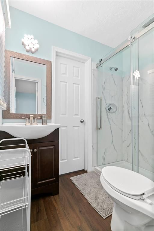 Bathroom, Glass Shower, Interior, Marble Walls, Wood Texture Flooring