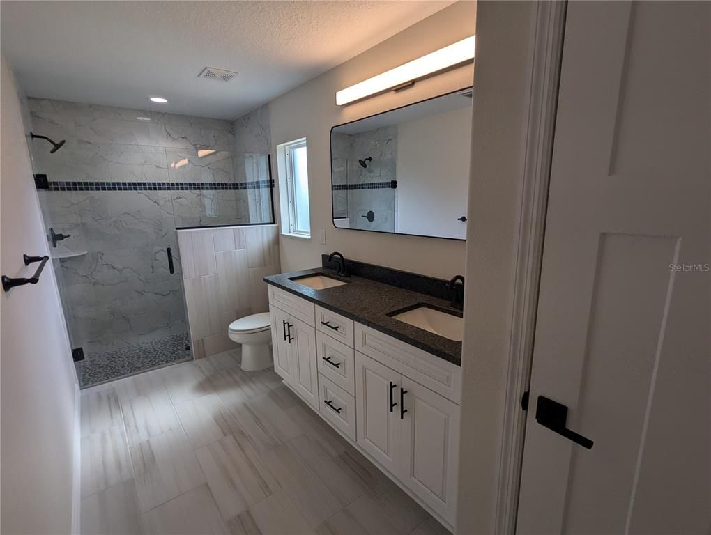 Bathroom, Dual Sink Vanities, Glass Shower, Interior, Marble, Marble Walls, Recessed Lighting