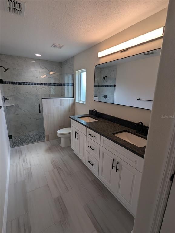 Bathroom, Dual Sink Vanities, Glass Shower, Interior, Marble Walls, Recessed Lighting
