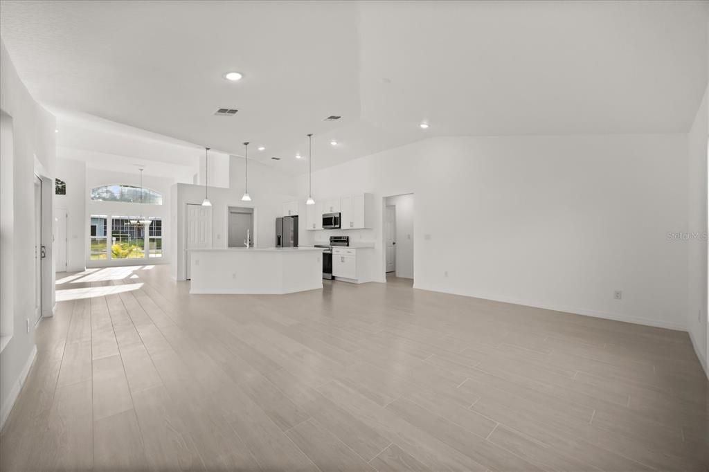 Empty room, Interior, Kitchen, Pendant Lights, Recessed Lighting, Stainless Steel Appliances, Wood Texture Flooring