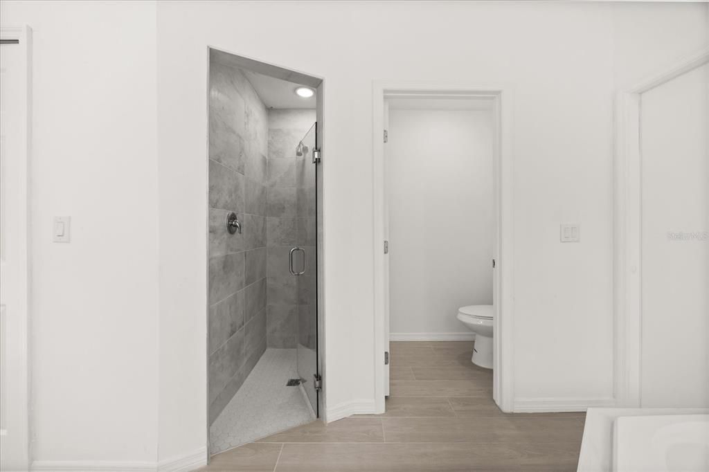 Bathroom, Glass Shower, Interior, Marble Walls, Recessed Lighting, Wood Texture Flooring