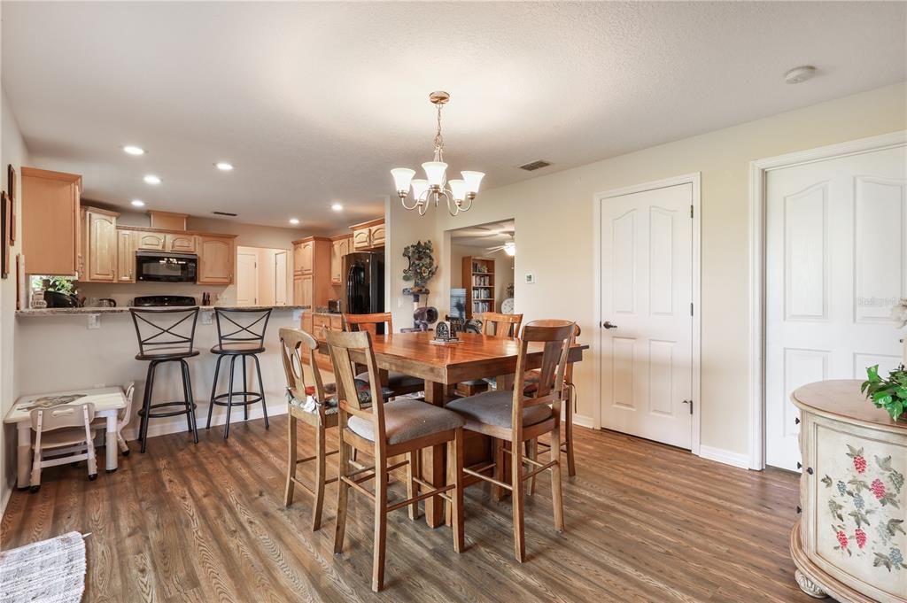 Chandelier, Dining room, Interior, Kitchen, Recessed Lighting, Stainless Steel Appliances, Wood Texture Flooring