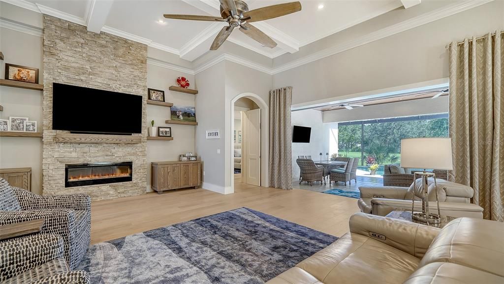 Dining room, Fireplace, Interior, Living room, Recessed Lighting, Stone Walls, Wood Texture Flooring