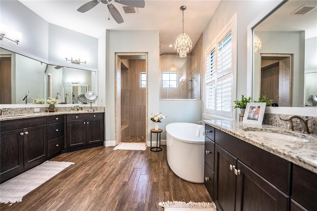 Bathroom, Chandelier, Dual Sink Vanities, Free Standing Baths, Glass Shower, Interior, Pendant Lights, Wood Texture Flooring