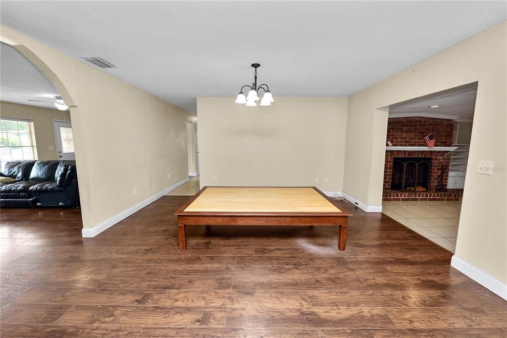 Billiard Table, Chandelier, Fireplace, Game Room, Interior, Stone Walls, Wood Texture Flooring