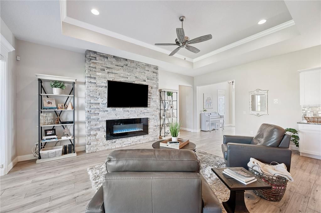 Fireplace, Interior, Living room, Recessed Lighting, Stone Walls, Wood Texture Flooring