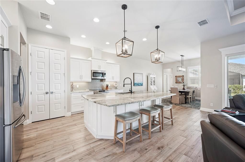 Dining room, Interior, Kitchen, Pendant Lights, Recessed Lighting, Stainless Steel Appliances, Wood Texture Flooring